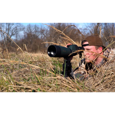 A man laying on his stomach using the-Alpen20-60x80-Waterproof Spotting Scope.