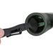 Alpen cleaning pen being used on a binocular lens.