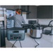 A man in the kitchen with a rice cooker plugged in a BaseCharge 1500.