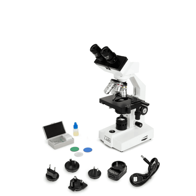 Celestron Labs CB1000CF Compound Microscope slightly facing left its accessories next to it.