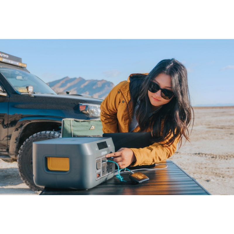 A woman out in the desert using a BaseCharge 1500.